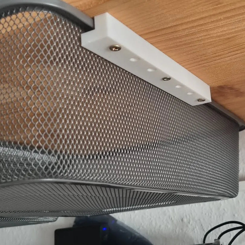 Mesh screen on a wooden surface with tools in the background