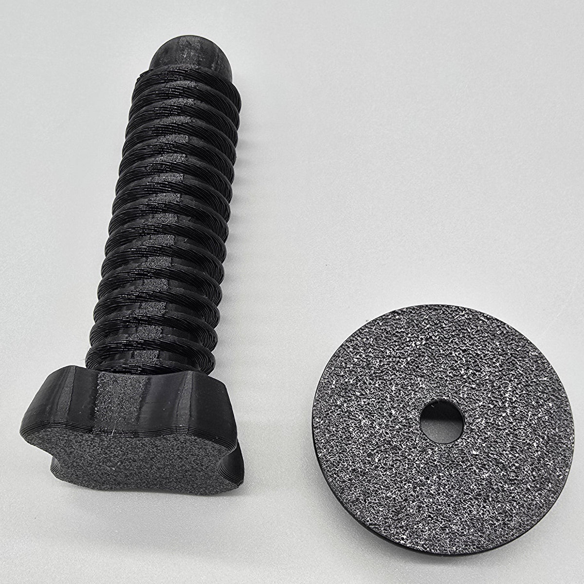 Black screw and Pad on a light gray background